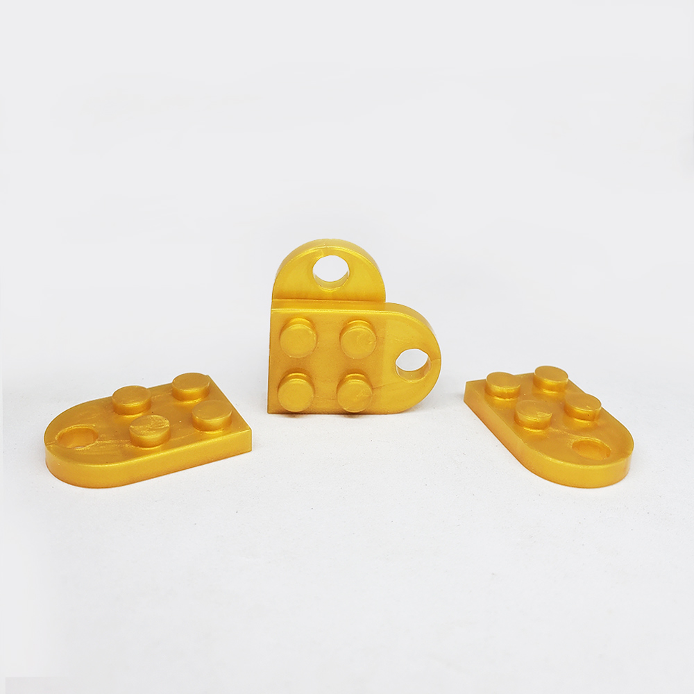 PAR DIJE LEGO PLASTICO DORADO 24*16MM